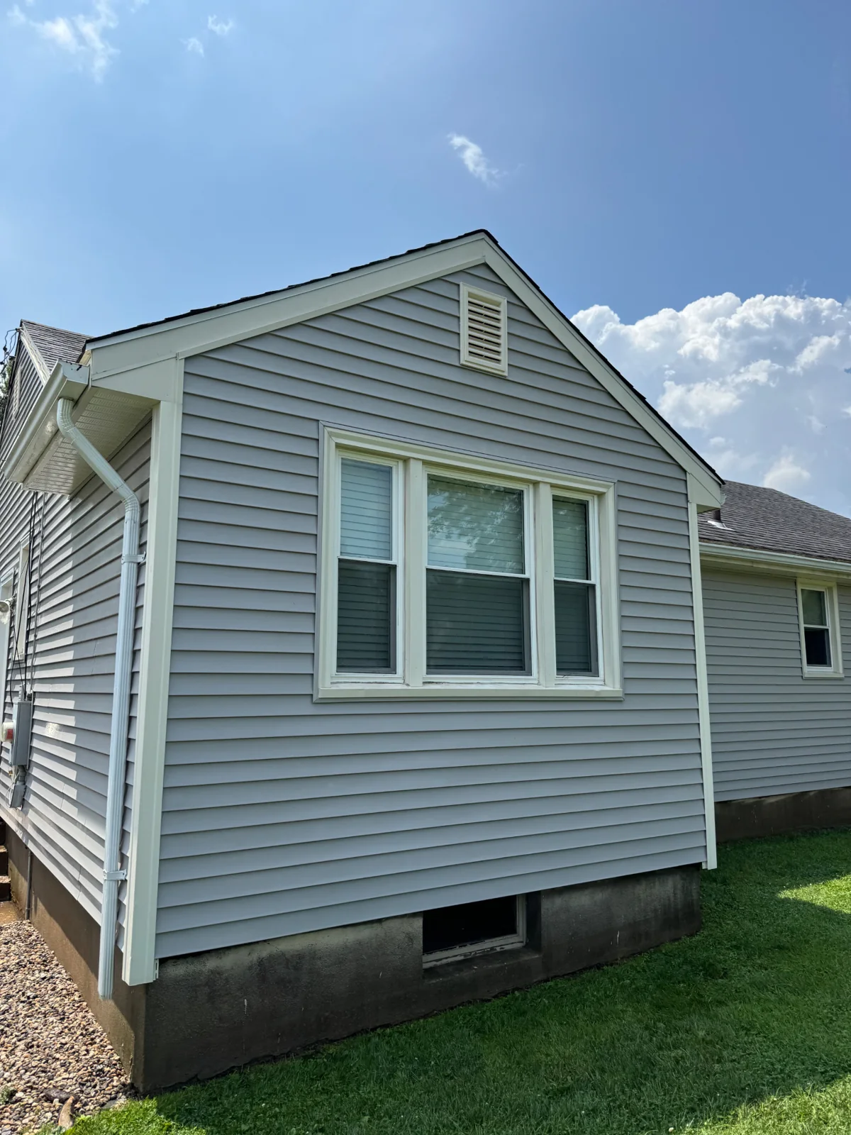 The same house siding clean after soft washing