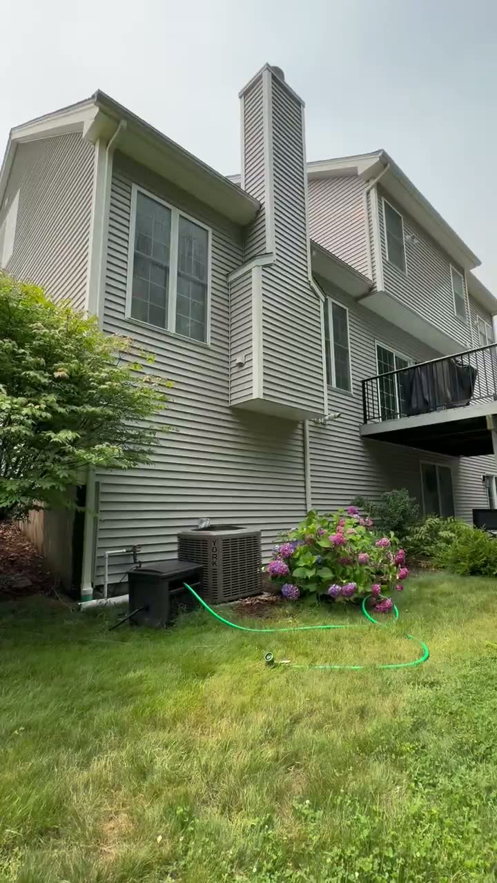 Technician soft washing a Connecticut home
