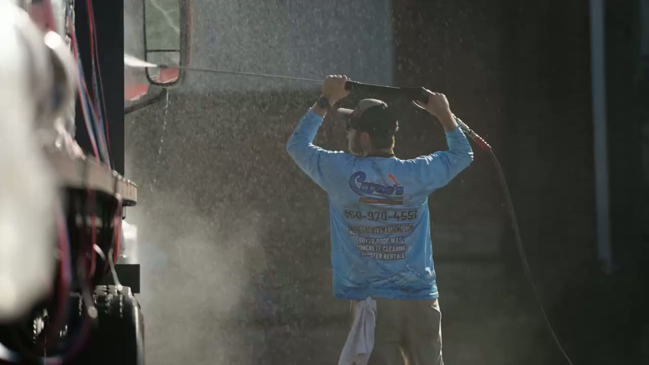 Technician soft washing the siding of a Connecticut home