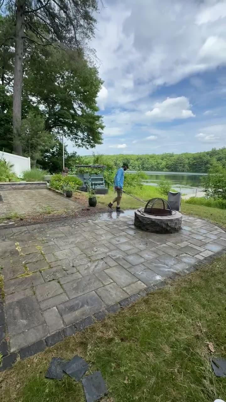 Cleaning a lakeside paver patio with a fire pit